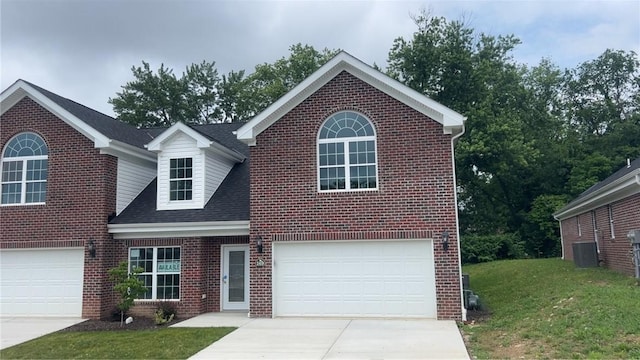 149 Shady River Blvd Unit 40B, Economy, PA 15005 - traditional-style home with concrete driveway, brick siding, a front yard, an attached garage, and roof with shingles