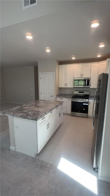 149 Shady River Blvd Unit 40B, Economy, PA 15005 - kitchen featuring appliances with stainless steel finishes, white cabinets, stone countertops, a center island, and recessed lighting