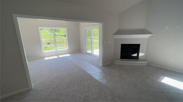 149 Shady River Blvd Unit 40B, Economy, PA 15005 - unfurnished living room with carpet, a tiled fireplace, and lofted ceiling