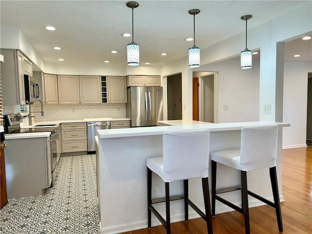 622 Fuhrman Ln, Buffalo Twp But, PA 16229 - kitchen featuring appliances with stainless steel finishes, gray cabinets, a breakfast bar, tasteful backsplash, and open shelves