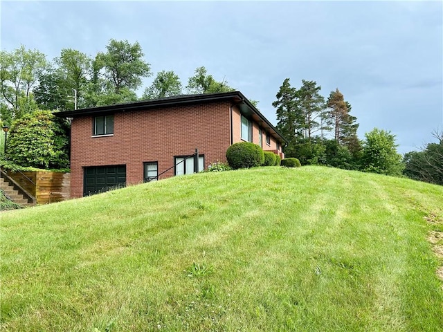 622 Fuhrman Ln, Buffalo Twp But, PA 16229 - view of side of property featuring an attached garage, brick siding, and a yard
