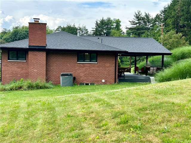 622 Fuhrman Ln, Buffalo Twp But, PA 16229 - view of home's exterior featuring a chimney, brick siding, roof with shingles, a lawn, and a patio