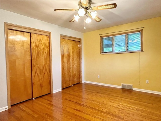 622 Fuhrman Ln, Buffalo Twp But, PA 16229 - unfurnished bedroom with multiple closets, wood finished floors, and ceiling fan
