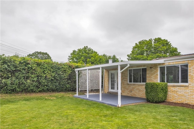 354 Ryan Dr, Pittsburgh, PA 15220 - back of house featuring brick siding, a yard, and a patio area