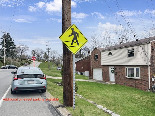 1492 Prospect Rd, Baldwin Boro, PA 15227 - view of front of house with brick siding, an attached garage, and a front yard