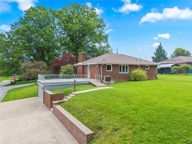 640 Susan Dr, North Huntingdon, PA 15642 - rear view of property featuring a lawn, a chimney, concrete driveway, and a wooden deck