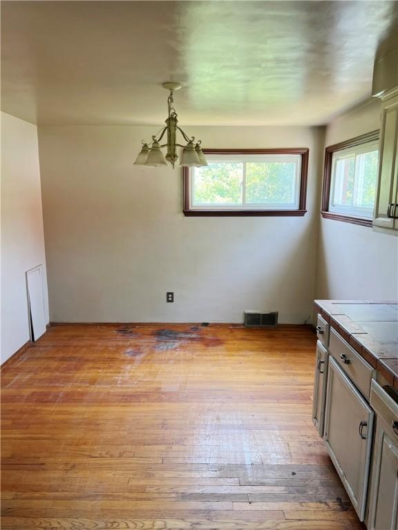 238 Humphrey Rd, Hempfield Twp Wml, PA 15601 - unfurnished dining area with a chandelier and light wood finished floors