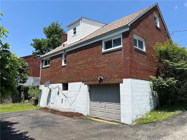 238 Humphrey Rd, Hempfield Twp Wml, PA 15601 - view of home's exterior featuring brick siding, an attached garage, and asphalt driveway