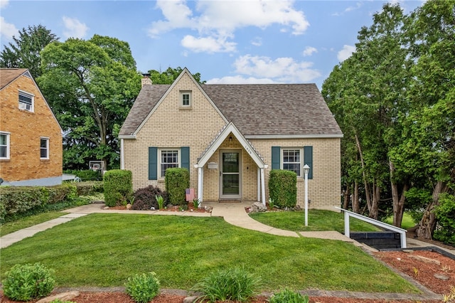 1406 Blossom Hill Rd, Castle Shannon, PA 15234 - tudor-style house with roof with shingles, a chimney, a front yard, and brick siding