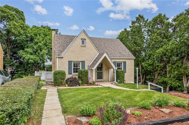 1406 Blossom Hill Rd, Castle Shannon, PA 15234 - tudor home featuring a chimney, brick siding, and roof with shingles