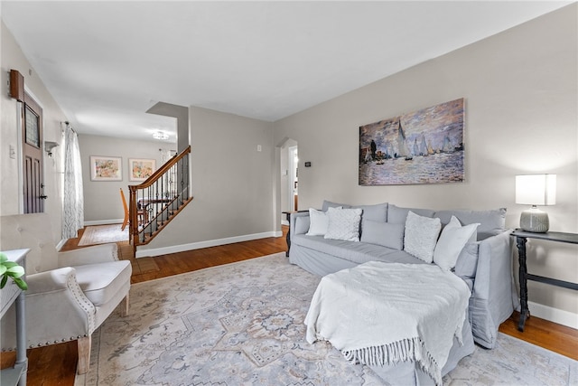1406 Blossom Hill Rd, Castle Shannon, PA 15234 - living room featuring stairs, arched walkways, and wood finished floors