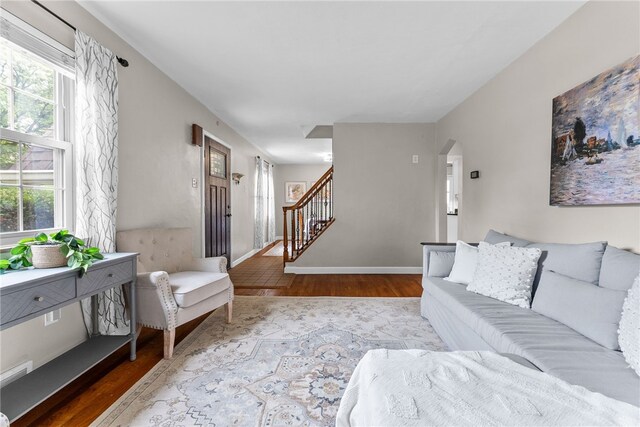 1406 Blossom Hill Rd, Castle Shannon, PA 15234 - living area featuring wood finished floors, stairs, and arched walkways