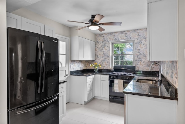 1406 Blossom Hill Rd, Castle Shannon, PA 15234 - kitchen with black appliances, wallpapered walls, white cabinets, a ceiling fan, and dark stone counters