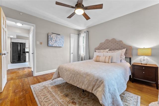1406 Blossom Hill Rd, Castle Shannon, PA 15234 - bedroom featuring freestanding refrigerator, wood finished floors, a closet, and a ceiling fan