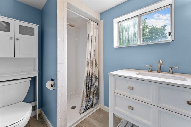 1406 Blossom Hill Rd, Castle Shannon, PA 15234 - bathroom with tiled shower, wood finished floors, and vanity