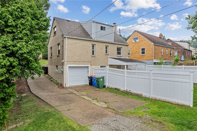 1406 Blossom Hill Rd, Castle Shannon, PA 15234 - view of home's exterior featuring an attached garage, a shingled roof, driveway, brick siding, and a chimney