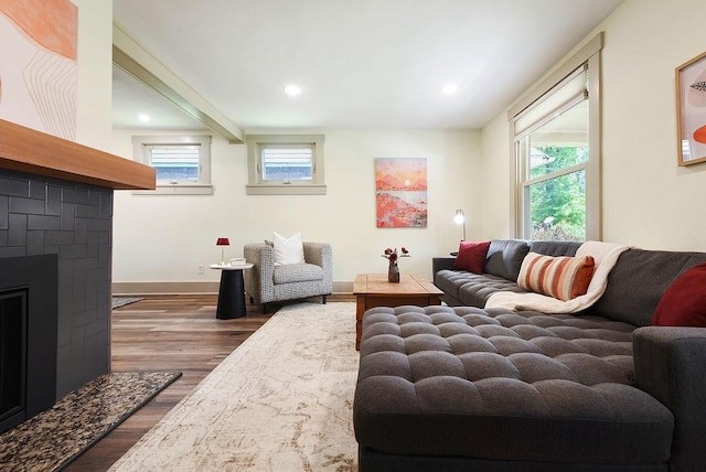 206 Lincoln Ave, Edgewood, PA 15218 - living area with healthy amount of natural light, dark wood-type flooring, a fireplace with flush hearth, and recessed lighting
