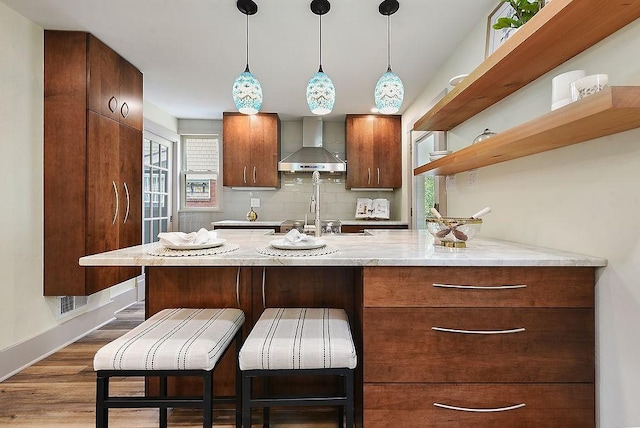 206 Lincoln Ave, Edgewood, PA 15218 - kitchen featuring wall chimney exhaust hood, open shelves, dark wood-type flooring, pendant lighting, and backsplash