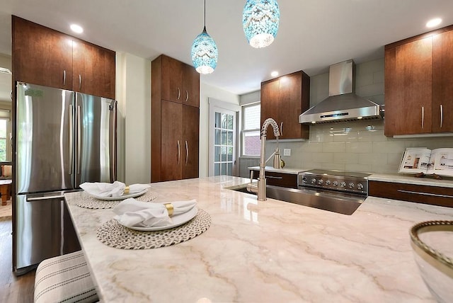 206 Lincoln Ave, Edgewood, PA 15218 - kitchen with wall chimney exhaust hood, stainless steel appliances, light stone countertops, pendant lighting, and tasteful backsplash