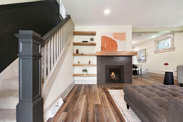 206 Lincoln Ave, Edgewood, PA 15218 - living area featuring stairs, wood finished floors, a brick fireplace, and recessed lighting