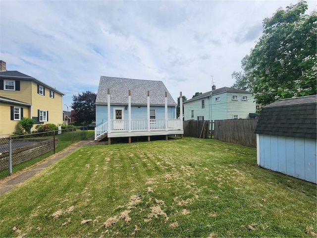 1025 Union Ave, Brackenridge, PA 15014 - rear view of property with a storage unit, a fenced backyard, a deck, and a shingled roof