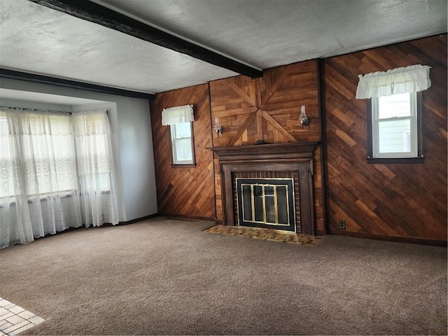 1025 Union Ave, Brackenridge, PA 15014 - unfurnished living room featuring wooden walls, beam ceiling, carpet floors, and a fireplace