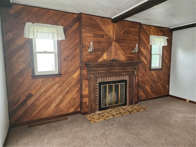1025 Union Ave, Brackenridge, PA 15014 - unfurnished living room with wooden walls, a brick fireplace, beam ceiling, and carpet flooring