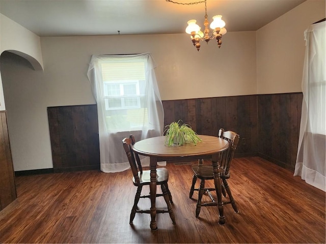 1025 Union Ave, Brackenridge, PA 15014 - dining area featuring wood finished floors, a chandelier, arched walkways, and wainscoting