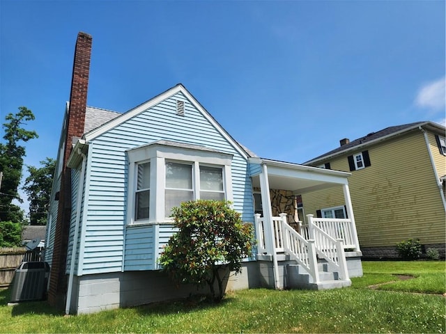 1025 Union Ave, Brackenridge, PA 15014 - view of front facade with a chimney, covered porch, and a front yard