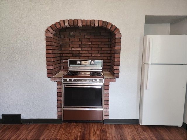 1025 Union Ave, Brackenridge, PA 15014 - kitchen with freestanding refrigerator, electric stove, and dark wood finished floors