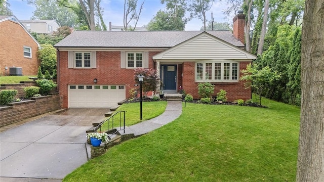 295 Twin Hills Dr, Mt Lebanon, PA 15216 - tri-level home featuring a chimney, an attached garage, driveway, brick siding, and a front yard