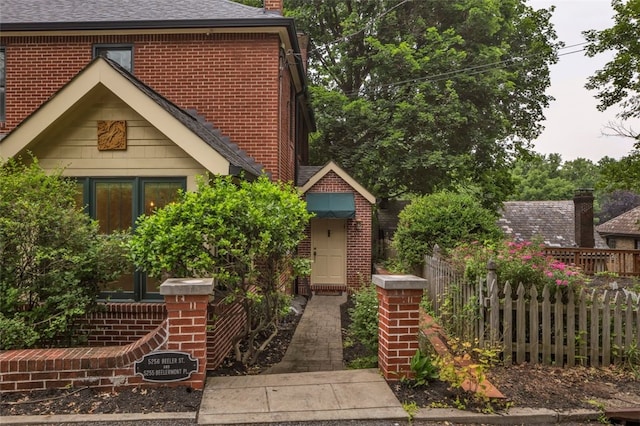5256 Beeler St, Squirrel Hill, PA 15217 - view of front facade with brick siding, a chimney, and roof with shingles