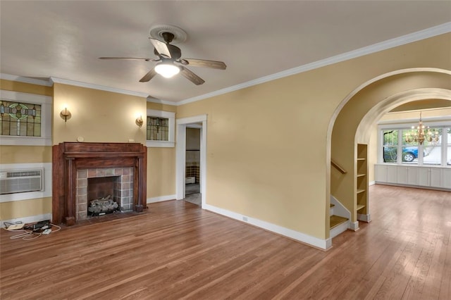 5256 Beeler St, Squirrel Hill, PA 15217 - unfurnished living room featuring a fireplace, stairs, wood finished floors, a wall mounted air conditioner, and a ceiling fan