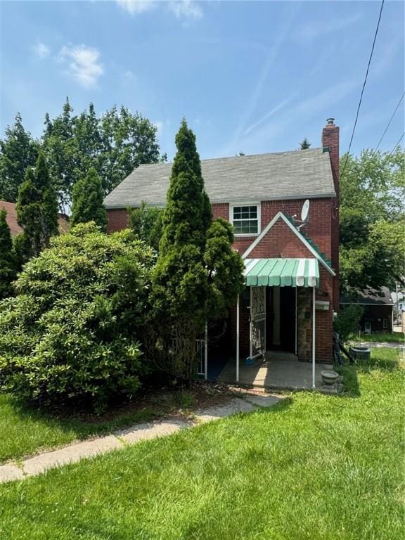 2205 Chalfant St, Chalfant Boro, PA 15221 - back of property with a lawn, a chimney, and brick siding