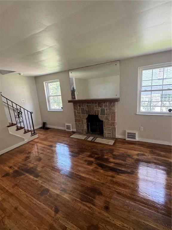 2205 Chalfant St, Chalfant Boro, PA 15221 - unfurnished living room with hardwood / wood-style flooring, stairs, and a fireplace