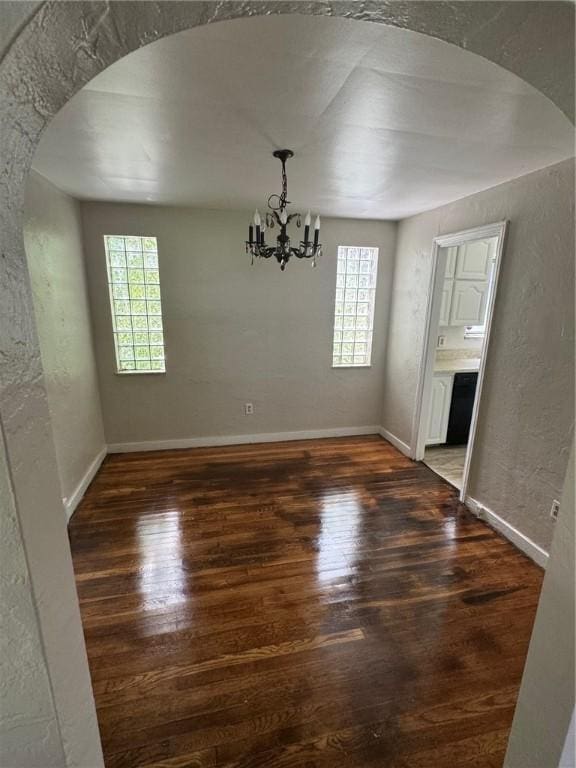 2205 Chalfant St, Chalfant Boro, PA 15221 - unfurnished dining area featuring arched walkways, plenty of natural light, wood finished floors, and a textured wall