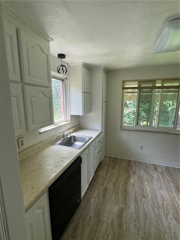 2205 Chalfant St, Chalfant Boro, PA 15221 - kitchen featuring black dishwasher, light countertops, wood finished floors, and white cabinetry