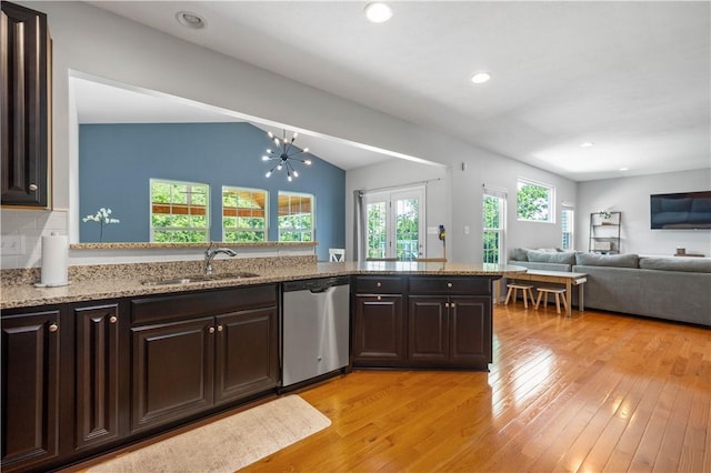 265 Sunrise Dr, Collier Twp, PA 15106 - kitchen with stainless steel dishwasher, light wood-style floors, dark brown cabinets, light stone counters, and vaulted ceiling