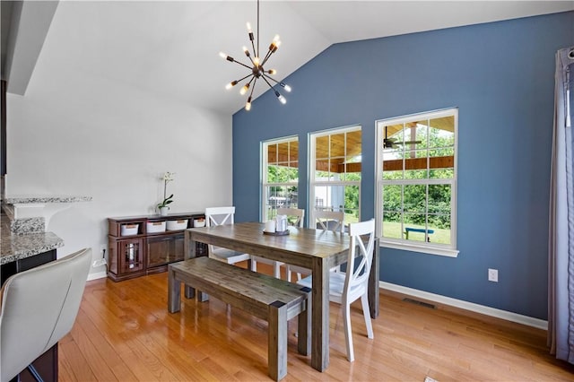 265 Sunrise Dr, Collier Twp, PA 15106 - dining area with a chandelier, lofted ceiling, and light wood finished floors