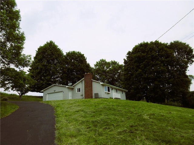 552 Heinz Camp Rd, Perry Twp Law, PA 16051 - view of front of property featuring a chimney, driveway, a front lawn, and a garage