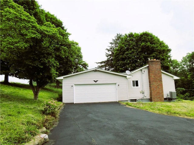 552 Heinz Camp Rd, Perry Twp Law, PA 16051 - view of home's exterior with a garage, a chimney, a lawn, and asphalt driveway