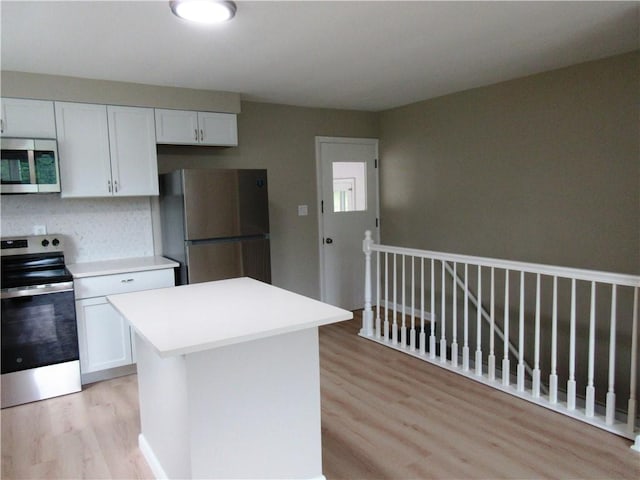 552 Heinz Camp Rd, Perry Twp Law, PA 16051 - kitchen with stainless steel appliances, light wood finished floors, light countertops, and white cabinets
