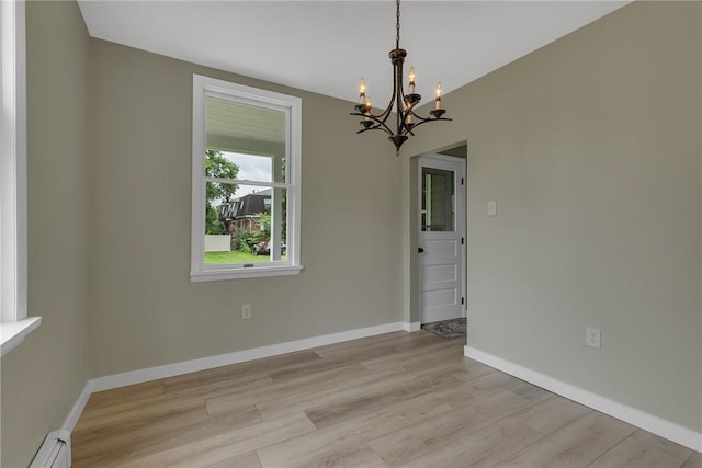 452 Canal St, Beaver, PA 15009 - unfurnished dining area with a chandelier, baseboard heating, and light wood-style floors