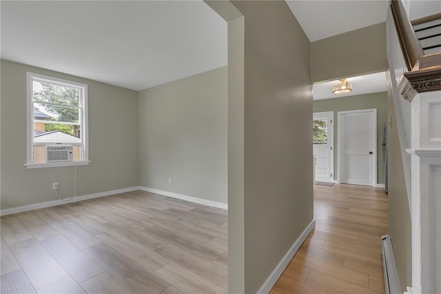 452 Canal St, Beaver, PA 15009 - empty room featuring light wood-style flooring, cooling unit, and a baseboard radiator