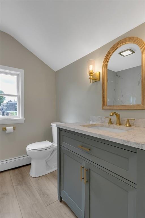 452 Canal St, Beaver, PA 15009 - bathroom featuring a baseboard heating unit, lofted ceiling, vanity, and wood finished floors