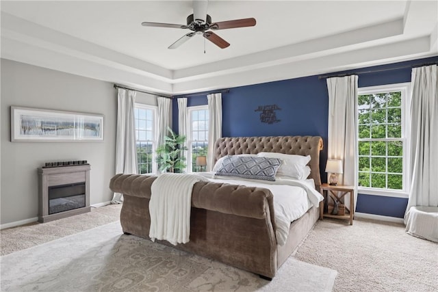 108 Ascot Ct, Lancaster Twp, PA 16037 - carpeted bedroom with a raised ceiling, a glass covered fireplace, and a ceiling fan