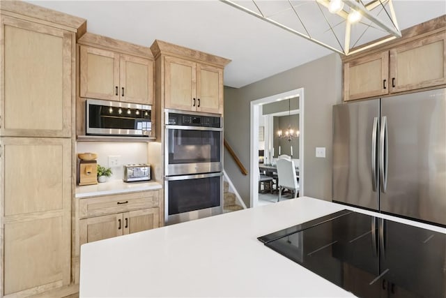 108 Ascot Ct, Lancaster Twp, PA 16037 - kitchen with stainless steel appliances, light brown cabinets, light countertops, and a chandelier