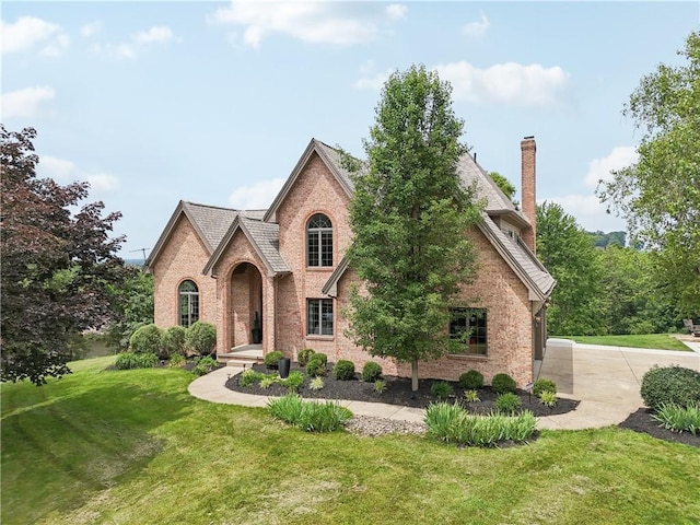 108 Ascot Ct, Lancaster Twp, PA 16037 - english style home featuring brick siding, a front lawn, and a chimney