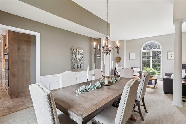 108 Ascot Ct, Lancaster Twp, PA 16037 - dining area with light carpet, a chandelier, wainscoting, and decorative columns