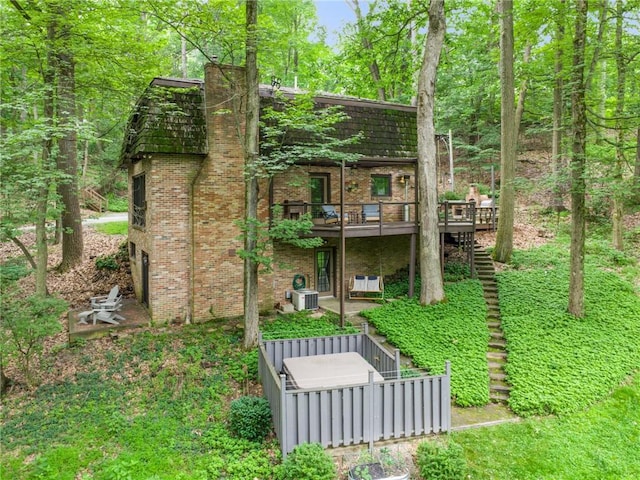 150 Buckwheat Dr, Pine Twp Nal, PA 15044 - back of house with a deck, brick siding, stairs, and a chimney
